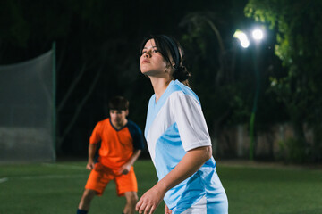 Female athlete playing football.