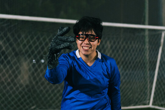 Hyped up goalkeeper smiling to the camera.
