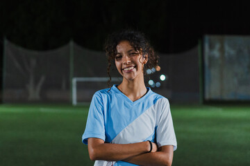 Latin non binary football player looking at the camera.