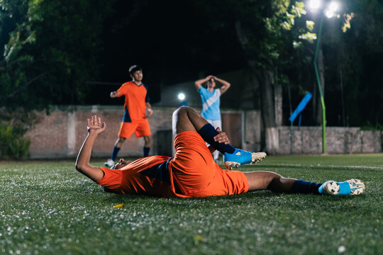 Injured football player on the ground.