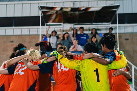 Football team forming a circle. 
