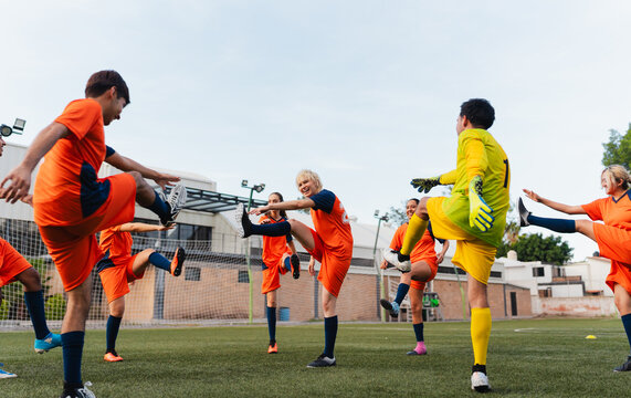 Soccer team warming up before a game at a football field.