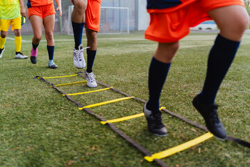Soccer players training in a football field.