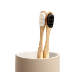 Bamboo tooth brushes in holder on white background, closeup