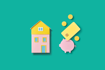 Paper piggy bank, coins and yellow credit card