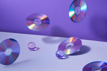 Floating CDs And Glass Orbs On Purple Background