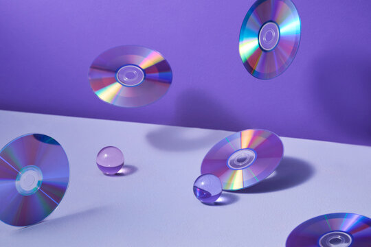 Floating CDs And Glass Orbs On Purple Background