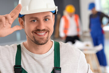 Male builder working in room, closeup