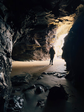 Person stood inside a sea cave in cornwall