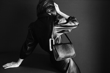 Elegant Woman in Black Leather Outfit With Stylish Handbag