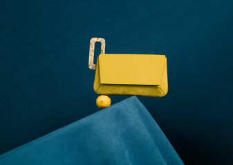 Modern Yellow Handbag on Blue Background with Lemon