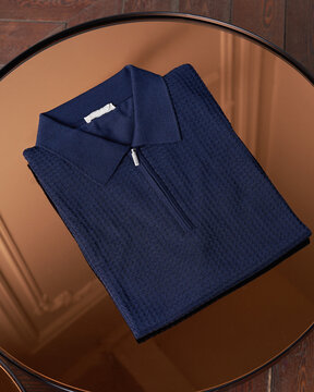Blue Knit Polo Shirt On Table
