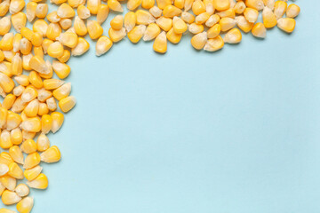 Fresh corn seeds on blue background