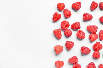 Many fresh raspberries on blue background