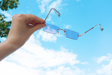 Metaphor conceptual photo of seeing life through pink/rosegold glasses