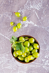 fresh organic gooseberries in a wooden bowl