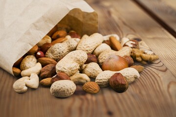 Tasty healthy mixed nuts on wooden desk
