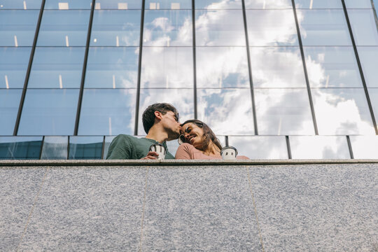 Romantic couple sharing a moment with coffee in Azca, Madrid