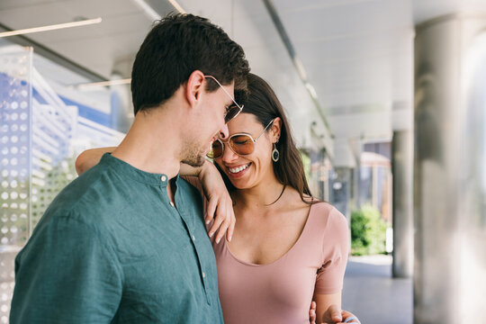 Smiling couple enjoying a sunny day in Azca, Madrid's urban area
