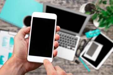 Hand typing on smartphone with blank screen