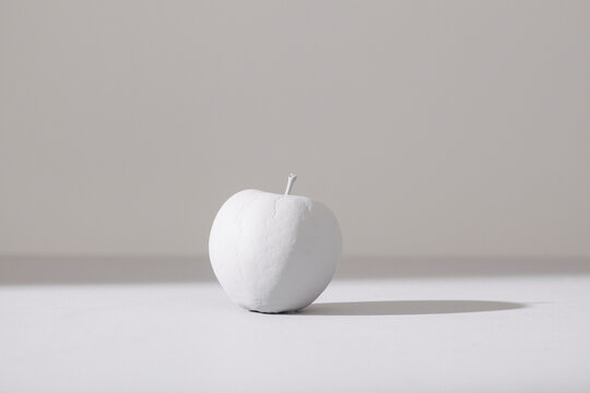 Minimalist White Apple on Neutral Background