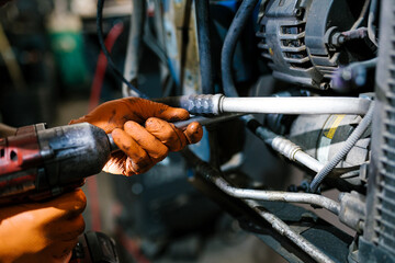Mechanic Working with Power Tool