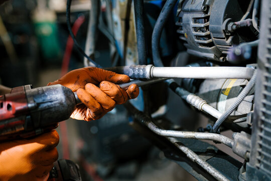 Mechanic Working with Power Tool