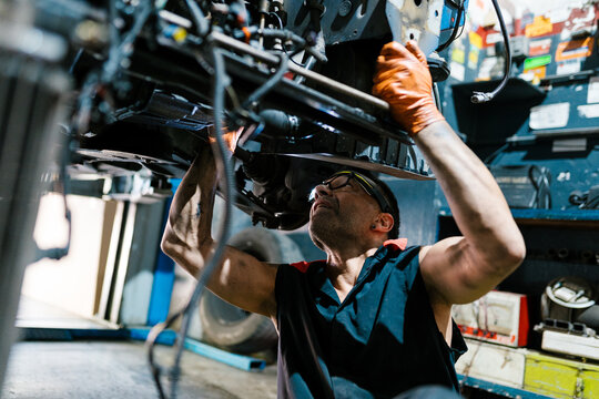 Mechanic Fixing Undercarriage