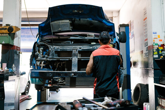 Mechanic Working Under Vehicle Hood