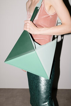 Fashionable Woman Holding Stylish Geometric Green Handbag