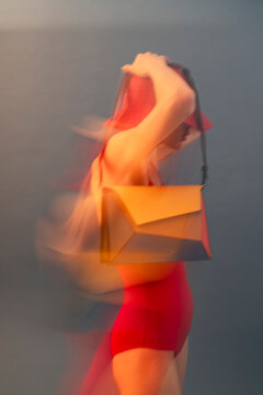 Abstract Blurred Motion Of Woman With Designer Purse