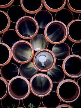 A large pile of pipes in a stack