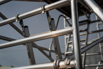 Construction scaffolding industry aluminium towers close up with ladder hook system attached to the...