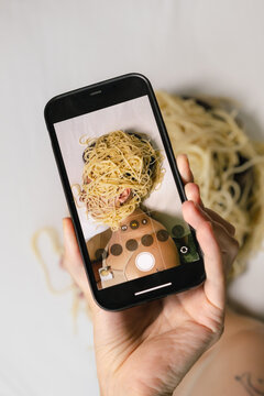 Person Taking Photo Of Themself Covered In Spaghetti