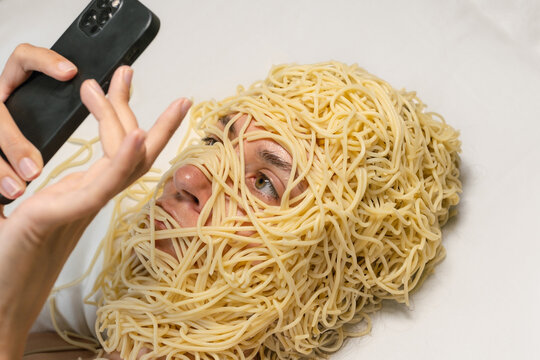 Woman Covered In Spaghetti Uses Phone