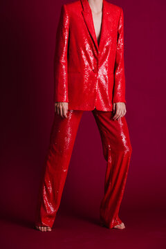 Fashion Model In Red Sequin Suit Against Purple Background