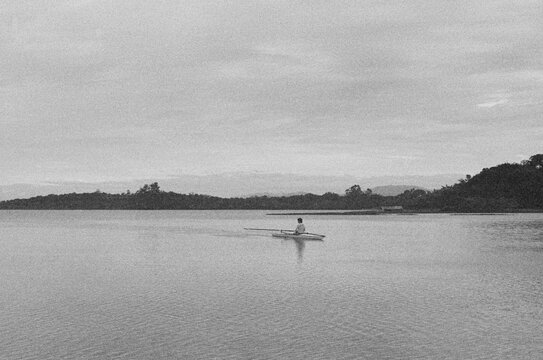 Man rowing alone in a still lake 