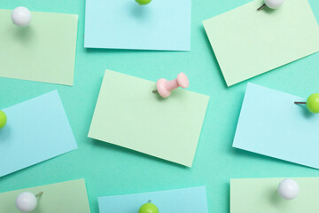 Paper notes pinned on turquoise background