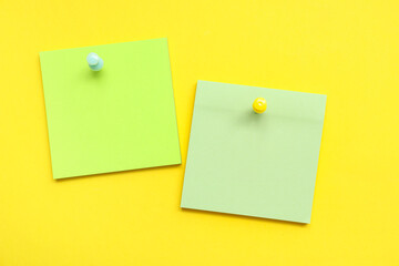 Paper notes pinned on yellow background