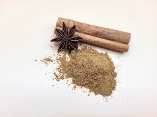 Aromatic pile of cinnamon and raw anise on a bright background.