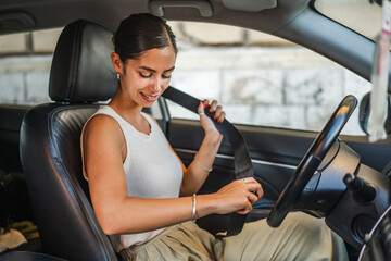 Young beautiful woman drive a car through the city