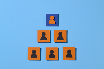 Business Hierarchy Pyramid with Leadership Symbol on Blue Background