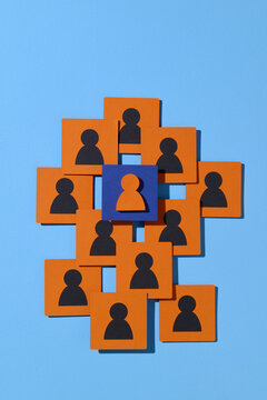 Group of People Icons Highlighting Central Figure on Blue Background