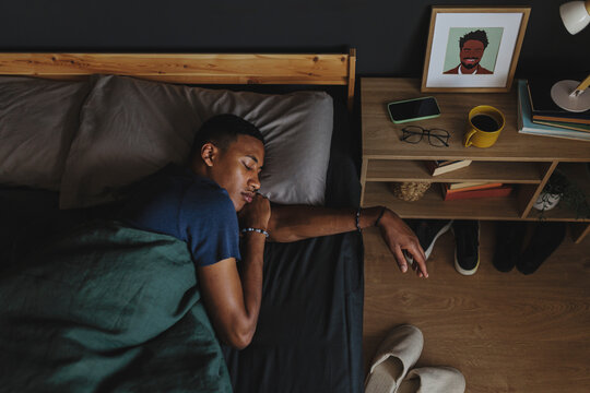 Man sleeping peacefully in bed after long day
