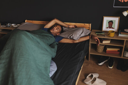 Man sleeping peacefully in bed after long day