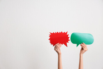 Female hands with different speech bubbles on white background