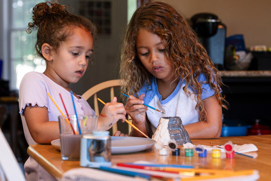 Girls Painting Model Volcano for School Project
 - Powered by Adobe