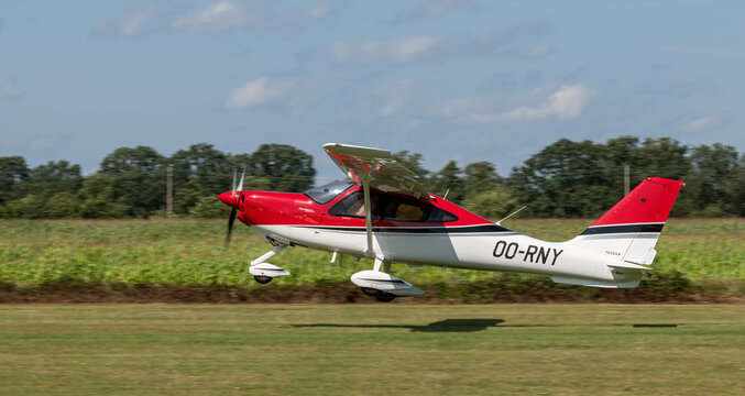 A light airplane with propeller, type Tecnam P2010 P TwentyTen during take off at Kiewit regional airport. Open house at aero kiewit. Propeller airplane with number 00-RNY. Open house organised on 24 