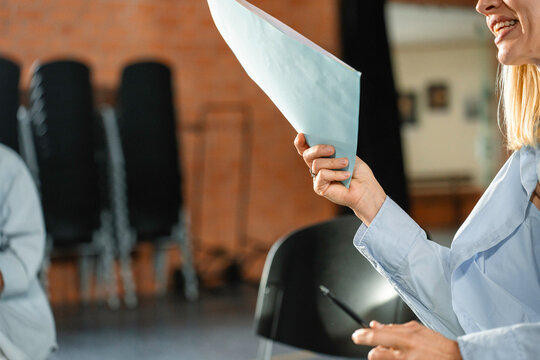 A woman holds a document in her hand