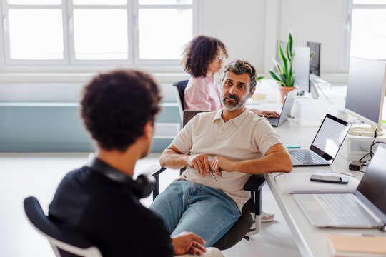 Manager explaining work strategy to employees in office